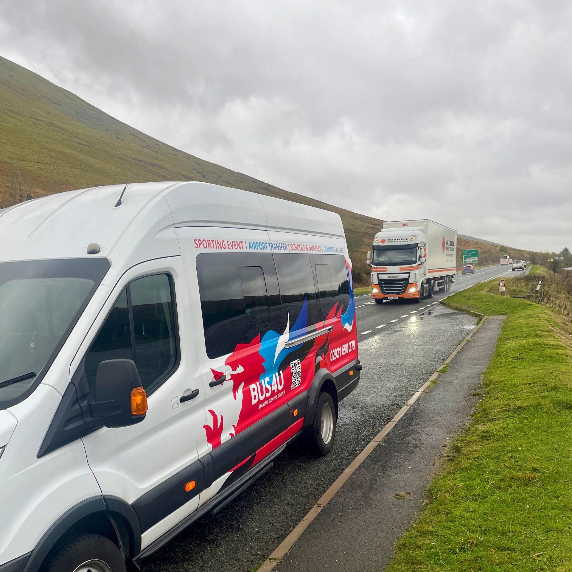 Bus4U branded minibus on Welsh road - professional minibus hire Cardiff for sporting events and airport transfers